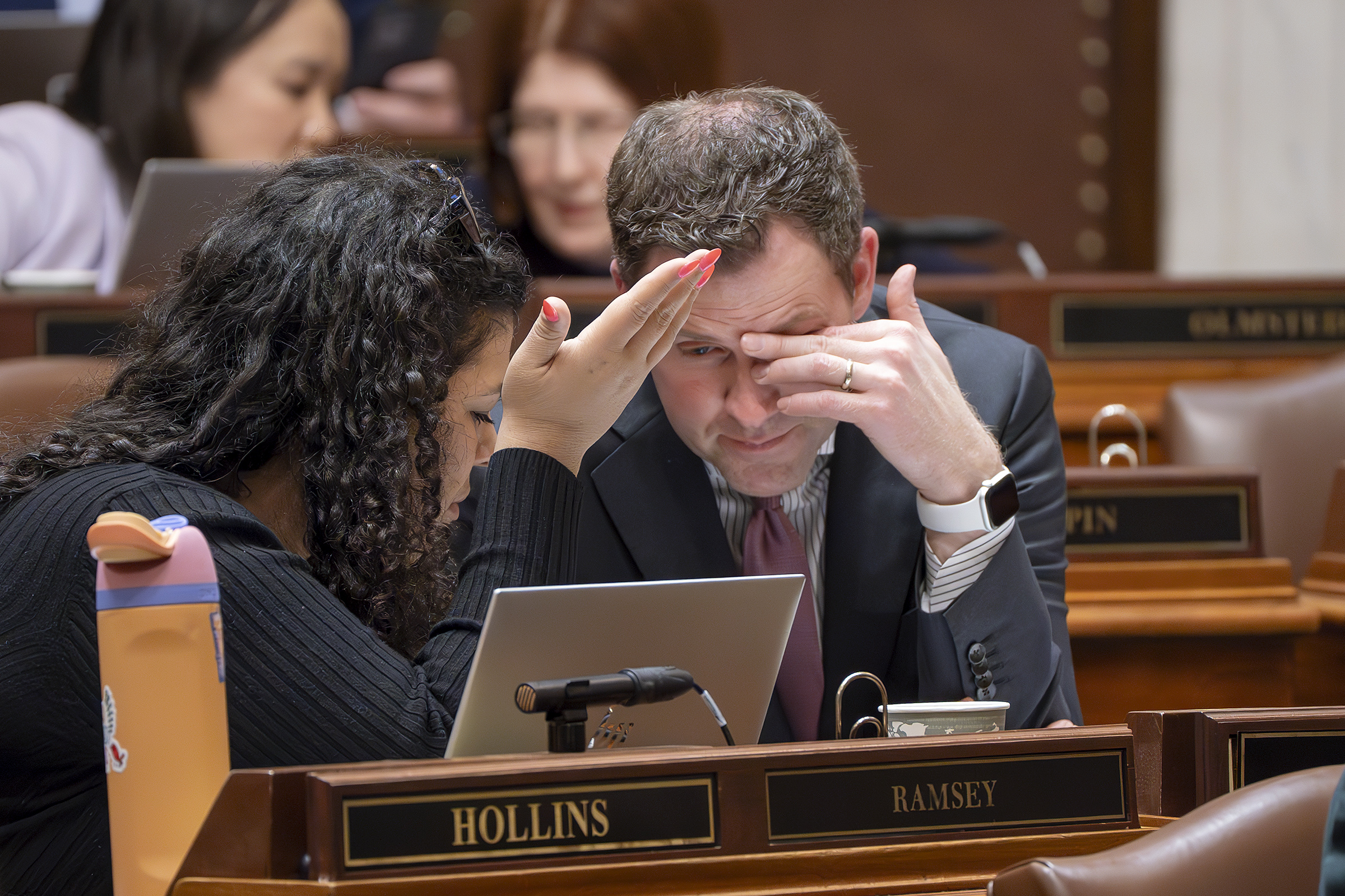 House Majority Leader Jamie Long confers with Rep. Athena Hollins during an April 11 House Floor session. (Photo by Michele Jokinen)